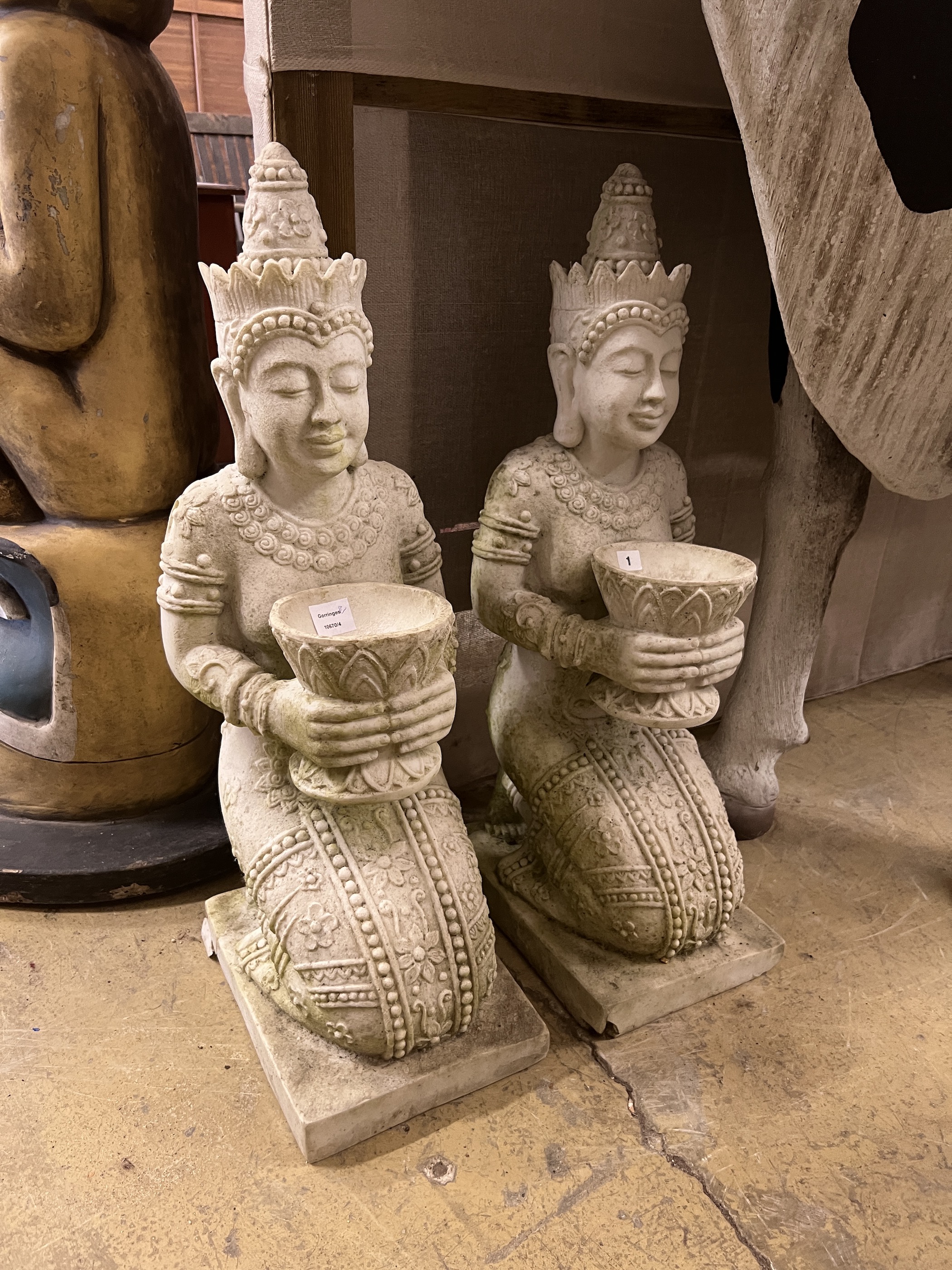 A pair of Thai style composition faux marble kneeling attendant garden ornaments, height 85cm